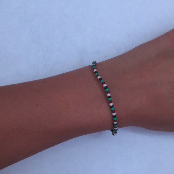 a cute small beaded bracelet that is white blue and 2 different colors of brown - Picture 2 of 2